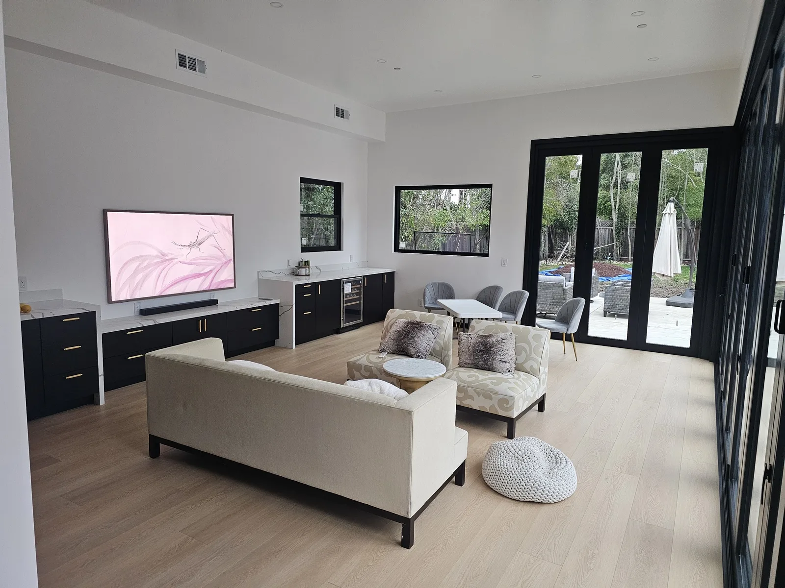 Hillsborough ADU, finished living room with bi-fold doors open to backyard, February 2026